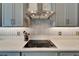 Modern kitchen featuring a stainless range hood, tile backsplash and quartz countertop at 31999 Surfton Knot Ct, San Antonio, FL 33576