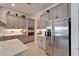 Modern kitchen with stainless steel appliances, ample counter space, and gray cabinets at 31999 Surfton Knot Ct, San Antonio, FL 33576