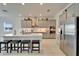 Bright kitchen featuring an island with seating, stainless steel appliances, and modern cabinets at 31999 Surfton Knot Ct, San Antonio, FL 33576