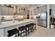 Modern kitchen featuring a large island with seating, stainless steel appliances, and designer cabinets at 31999 Surfton Knot Ct, San Antonio, FL 33576