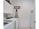Clean laundry area featuring a modern washer and dryer, with white walls and ample lighting at 31999 Surfton Knot Ct, San Antonio, FL 33576