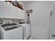 Well-organized laundry room with modern washer and dryer units and ample storage space at 31999 Surfton Knot Ct, San Antonio, FL 33576