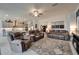 Inviting living room with tile floors, ceiling fan, and comfortable, oversized seating at 31999 Surfton Knot Ct, San Antonio, FL 33576
