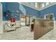 Inviting lobby with a reception desk, comfortable seating, and modern decor against a striking blue wall at 31999 Surfton Knot Ct, San Antonio, FL 33576