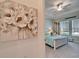 Bright bedroom features tray ceiling, ceiling fan, and coastal decorations at 31999 Surfton Knot Ct, San Antonio, FL 33576