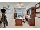 Home office with wood desk, ceiling fan, and natural light for a productive workspace at 31999 Surfton Knot Ct, San Antonio, FL 33576