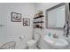 Charming powder room with decorative shelves, a stylish sink, and lovely wall art at 31999 Surfton Knot Ct, San Antonio, FL 33576