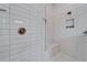 Modern shower with sleek white tiling, a built-in bench, and a rainfall showerhead at 31999 Surfton Knot Ct, San Antonio, FL 33576