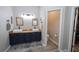 Bathroom featuring double sink vanity, wood counters, vessel sinks, blue cabinets and fixtures at 3233 Russett Pl, Land O Lakes, FL 34638