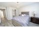 Bedroom with neutral colors, a closet, and a lamp on the dresser at 3233 Russett Pl, Land O Lakes, FL 34638