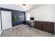 Home office with desk, dark accent wall, light wood floors, and ample natural light at 3233 Russett Pl, Land O Lakes, FL 34638