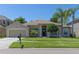 Charming single-story home featuring a well-manicured lawn, attached garage, and inviting front entrance at 3233 Russett Pl, Land O Lakes, FL 34638
