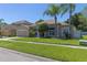 Inviting single-story home with attached garage, lush green lawn, and a classic residential neighborhood at 3233 Russett Pl, Land O Lakes, FL 34638