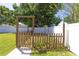 Charming backyard garden with a rustic wooden fence, walkway, and lush greenery, creating a serene outdoor space at 3233 Russett Pl, Land O Lakes, FL 34638