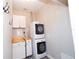 Efficient laundry area with stacked washer and dryer, butcher block folding area, and cabinetry at 3233 Russett Pl, Land O Lakes, FL 34638