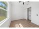 A bright bedroom featuring wood-look floors, a ceiling fan, and a closet at 3515 Nemo Ave, North Port, FL 34287