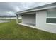 Spacious outdoor patio with a concrete slab and pond is perfect for entertainment at 35478 Bellington Blvd, Zephyrhills, FL 33541