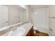 Well-lit bathroom featuring a shower-tub combo, spacious countertop, and wood-look flooring at 35478 Bellington Blvd, Zephyrhills, FL 33541