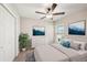 Bright bedroom featuring a ceiling fan, serene wall art, and neutral-toned furnishings at 35478 Bellington Blvd, Zephyrhills, FL 33541