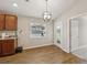 Featuring a breakfast nook with wood flooring, modern light fixture and sliding glass door to yard at 35478 Bellington Blvd, Zephyrhills, FL 33541
