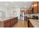 Kitchen featuring stainless steel appliances, wood cabinets, island with a sink, and modern wood flooring at 35478 Bellington Blvd, Zephyrhills, FL 33541