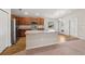 A kitchen featuring stainless steel appliances, an island with sink, and modern wood flooring at 35478 Bellington Blvd, Zephyrhills, FL 33541