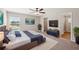 A spacious main bedroom, with a ceiling fan, a flat screen TV, a walk-in closet, and a connected bathroom at 35478 Bellington Blvd, Zephyrhills, FL 33541