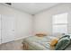 Bedroom with wood-look flooring and window with blinds at 3579 Sweet Mabolo St, Wesley Chapel, FL 33543