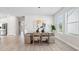 Bright dining room with modern table, neutral walls, and hardwood flooring at 3579 Sweet Mabolo St, Wesley Chapel, FL 33543