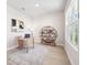 Bright home office featuring minimalist decor and a spacious desk with natural light from the window at 3579 Sweet Mabolo St, Wesley Chapel, FL 33543