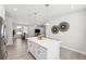 Open-concept kitchen with a large island, stainless steel appliances, and views of the dining and living areas at 3579 Sweet Mabolo St, Wesley Chapel, FL 33543