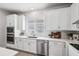 Well-lit kitchen with white cabinets, stainless steel appliances, and light countertops at 3579 Sweet Mabolo St, Wesley Chapel, FL 33543