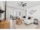 Inviting living room with comfortable seating, contemporary decor, and sliding doors to the patio at 3579 Sweet Mabolo St, Wesley Chapel, FL 33543