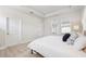 Light and bright main bedroom with tray ceiling, ensuite bathroom, and light wood-look flooring at 3579 Sweet Mabolo St, Wesley Chapel, FL 33543
