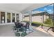 Covered patio with outdoor dining set, offering a perfect space for relaxation and entertaining at 3579 Sweet Mabolo St, Wesley Chapel, FL 33543