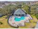 Community amenities featuring a pool, clubhouse, and surrounding mature trees at 3638 Trafalgar Way # 103, Palm Harbor, FL 34685