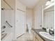 Bright bathroom with tub/shower, storage closet, and vanity with neutral countertops at 3638 Trafalgar Way # 103, Palm Harbor, FL 34685