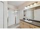 Bright bathroom with a glass-enclosed shower and vanity with neutral countertops at 3638 Trafalgar Way # 103, Palm Harbor, FL 34685