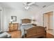 Inviting bedroom featuring a wood bed frame, neutral decor, and a light-filled ambiance at 3638 Trafalgar Way # 103, Palm Harbor, FL 34685