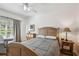 Bedroom with a wood bed frame, a window with curtains, and warm, neutral colors at 3638 Trafalgar Way # 103, Palm Harbor, FL 34685