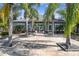 Inviting clubhouse exterior featuring palm trees and meticulously landscaped entrance at 3638 Trafalgar Way # 103, Palm Harbor, FL 34685