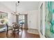 Open dining area showcasing a round table with chairs, a stylish chandelier, and lots of natural light at 3638 Trafalgar Way # 103, Palm Harbor, FL 34685