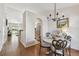 Inviting dining room with chandelier and a view into the kitchen and living area, creating an open and airy feel at 3638 Trafalgar Way # 103, Palm Harbor, FL 34685