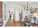 Inviting dining room with chandelier and a view into the kitchen and living area, creating an open and airy feel at 3638 Trafalgar Way # 103, Palm Harbor, FL 34685