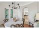 Dining area featuring an elegant chandelier, a table set for six, and a seamless flow into the kitchen area at 3638 Trafalgar Way # 103, Palm Harbor, FL 34685