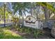 Stone Waterford Condominium Residences entrance sign amidst lush landscaping at 3638 Trafalgar Way # 103, Palm Harbor, FL 34685