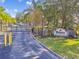 Gated entrance to Waterford Condominium Residences with a beautifully landscaped sign at 3638 Trafalgar Way # 103, Palm Harbor, FL 34685
