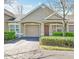 Charming home with a garage, well-maintained landscaping, and a cozy front entrance, offering great curb appeal at 3638 Trafalgar Way # 103, Palm Harbor, FL 34685