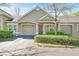 Exterior view showcasing the home's front entrance, garage, and well-manicured landscaping at 3638 Trafalgar Way # 103, Palm Harbor, FL 34685