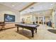 Well-appointed game room featuring a classic pool table, tile flooring, and abundant light at 3638 Trafalgar Way # 103, Palm Harbor, FL 34685